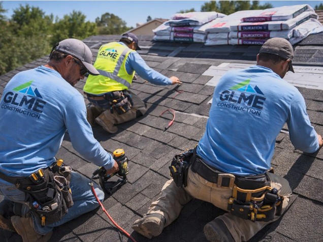 GLME Construction workers installing roof shingles